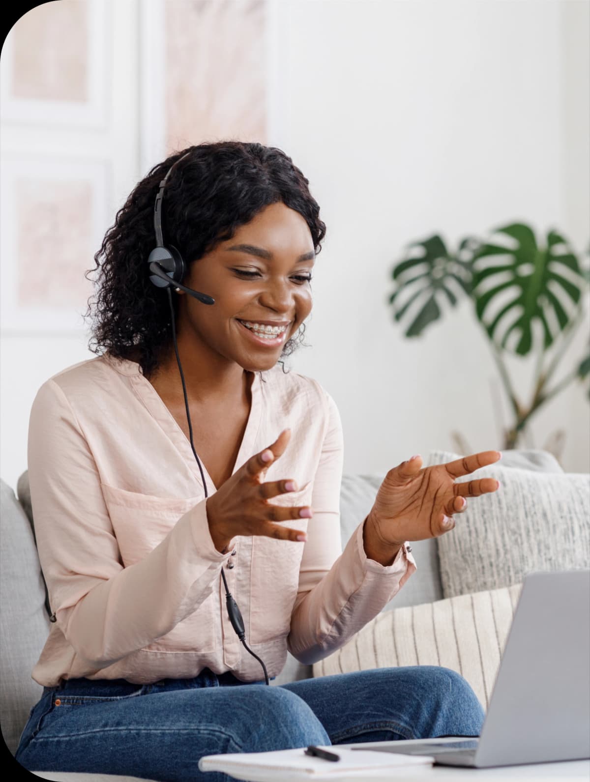 Businesswoman wearing a headset smiling on a video call from home